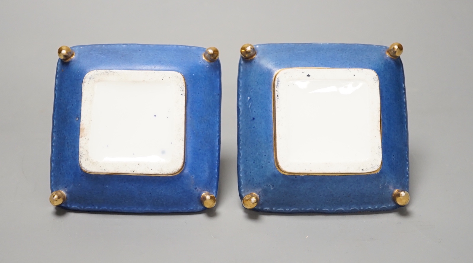 A pair of mid 19th century Paris porcelain 'cushion' shaped scent bottles decorated in Sevres style with pink roses (lacking stoppers)
